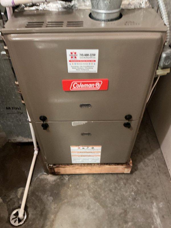 Responded to no cool complaint with water leaking near furnace in utility closet. Upon inspection, discovered active water leak originating from evaporator coil drain pan area on 25-year-old R22 air conditioning system. Determined leak was caused by either improper drain pan pitch or cracked drain pan at rear of coil. Additionally found evaporator coil improperly installed without coil shelf support—unit was resting only on screws mounted in plenum, contributing to drainage issues. System still operational but requires immediate attention to prevent water damage. Presented customer with options to further investigate and repair evaporator coil assembly or pursue full system replacement given age and R22 refrigerant status.