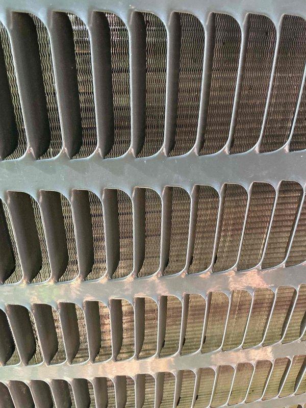 Responded to no cooling complaint on 10-year-old HVAC system. Upon inspection, found outdoor condenser coil heavily plugged with debris and dirt buildup, significantly restricting airflow and reducing heat transfer efficiency. Indoor furnace filter also found severely plugged. Thoroughly cleaned outdoor coil fins to restore proper airflow through the unit. Advised homeowner to replace furnace filter to maintain system performance. System airflow restored, unit operating properly after cleaning.