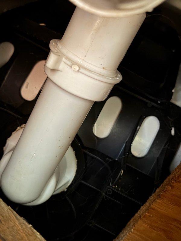 Responded to water leak complaint originating from bathtub drain assembly and manifesting in basement below. Upon inspection, identified active leak at slip joint fittings on 1-1/4" drain pipe assembly. Determined fittings were inadequately tightened and lacked proper thread sealant. Disassembled slip joint connections, applied pipe dope to threaded components, and properly torqued all fittings to manufacturer specifications. Verified repair integrity and confirmed leak elimination. Documented plumbing configuration with photographic evidence showing PVC drain assembly and slip joint connections beneath fixture.