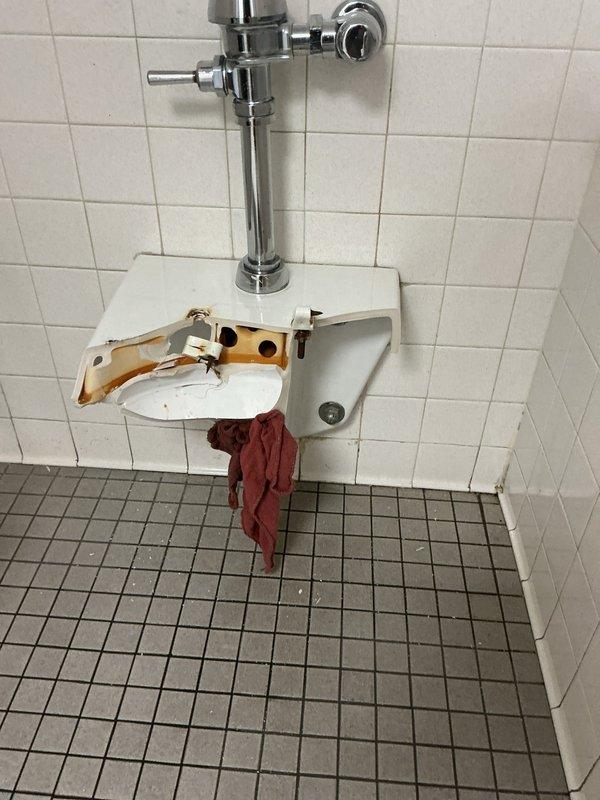 Responded to emergency call for failed wall-mounted toilet fixture that completely separated from wall mounting system during use, causing the porcelain bowl to shatter. Removed damaged toilet bowl and assessed wall carrier system for structural integrity. Installed new wall-mounted toilet fixture with proper carrier mounting, ensuring secure attachment to wall framing and connection to existing flush valve assembly and waste line. Tested installation for stability and proper flush operation.