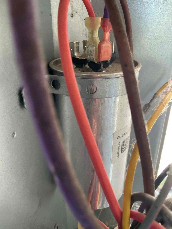 Responded to no cooling complaint on 8-year-old residential air conditioning system. Diagnosed failed capacitor and plugged outdoor coil restricting airflow and reducing cooling efficiency. Replaced defective capacitor, installed hard start kit to improve compressor performance, cleaned outdoor coil with solvent to restore proper heat transfer, and added locking refrigerant caps for theft prevention. System tested and restored to normal cooling operation.