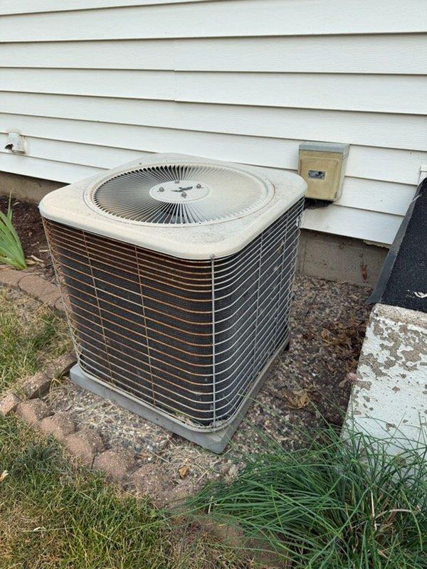 Responded to no cooling complaint on a 2012 residential air conditioning system. Upon arrival, found the outdoor condensing unit inoperative with customer reporting louder than normal motor operation prior to failure. Diagnostic testing identified a failed dual run capacitor preventing compressor and condenser fan motor operation. Replaced defective capacitor with proper OEM-spec replacement, restored power to unit, and verified normal compressor and fan motor startup with proper amperage draw. System cycled properly and returned to normal cooling operation.
