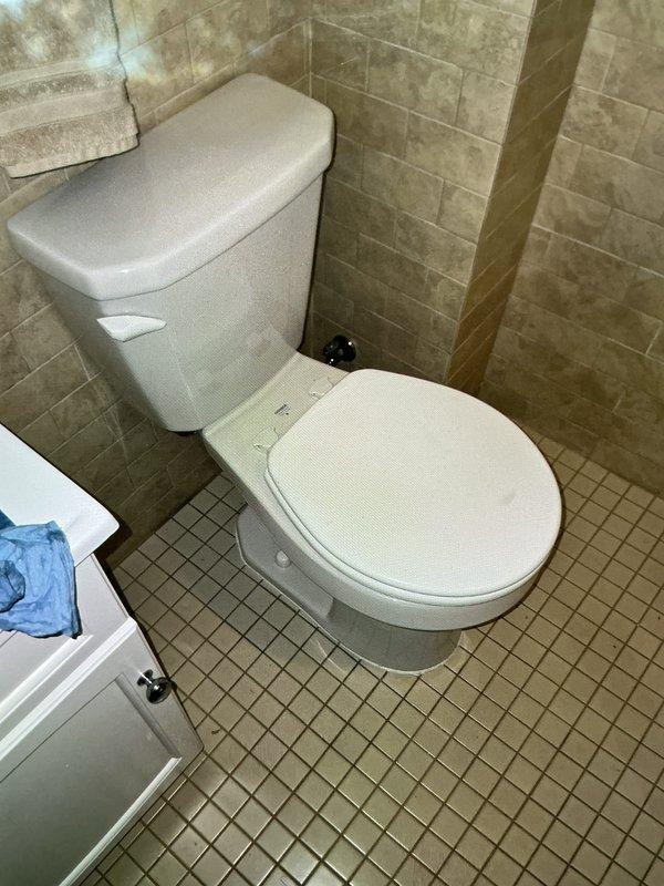 Responded to service call for broken toilet flange repair. Upon arrival, found severely corroded and deteriorated cast iron closet flange with extensive rust damage and structural failure. Removed damaged 4" closet flange assembly and prepared floor opening for replacement. Installed new metal repair collar and closet flange, securing all fasteners properly to ensure stable toilet mounting. Verified proper alignment and structural integrity of new flange installation. Documented existing conditions and completed repairs with photographic evidence.