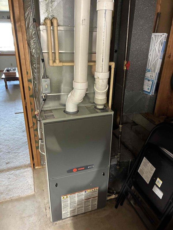 Responded to service call for loud noise and vibration from HVAC system during cooling operation. Upon inspection, discovered entire furnace shaking violently when blower motor engaged. Identified root cause as paper backing from air filter that had not been removed during previous filter change, which was subsequently pulled into blower wheel assembly causing severe imbalance. Removed foreign material from blower wheel, eliminating vibration and noise issue. Verified air conditioning unit operational age at 34 years with newer furnace installation. Connected manifold gauges to refrigeration system and confirmed operating pressures within acceptable parameters. Unit currently cooling effectively following repair. Discussed equipment age and reliability concerns with homeowner given the advanced age of outdoor condensing unit. Scheduled comfort advisor consultation for system replacement evaluation.