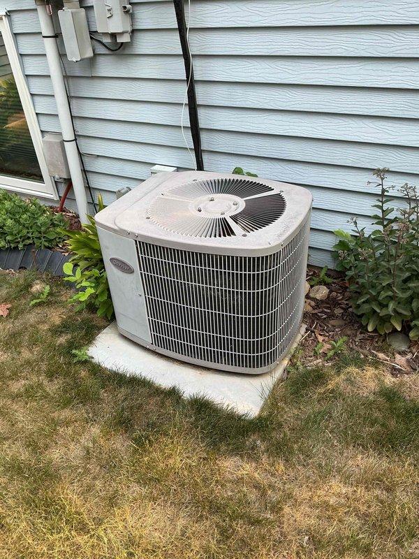 Responded to no cooling complaint on Carrier air conditioning system. Upon arrival, found indoor unit operating but outdoor condensing unit not running despite contactor being energized. Diagnosed failed dual run capacitor preventing compressor and condenser fan operation. Replaced defective capacitor with new unit, performed coil cleaning on outdoor unit, and verified proper system operation with normal cooling restored.