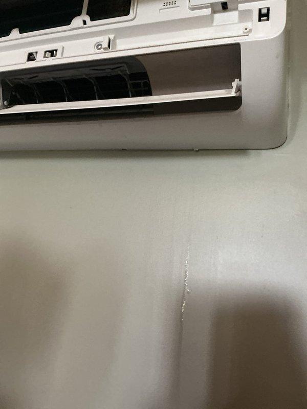 Responded to service call for water leaking from upstairs mini split indoor head unit on a 10-year-old air conditioning system. Upon inspection, identified clogged condensate drain line causing water to overflow and run down the wall below the unit. Opened the indoor unit's front cover to access the drain pan and blower assembly, then successfully cleared the blockage from the condensate drain line. Removed and inspected the air filter, which showed accumulated debris. Verified proper drainage flow after clearing the obstruction and confirmed no further water leakage from the unit.