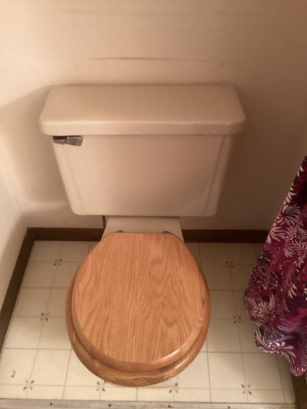 Responded to a call for a leaking toilet at a residential property. Upon inspection, identified that a loose screw connecting the toilet tank to the bowl was causing the leak. Tightened the tank-to-bowl mounting hardware to secure the connection and stop the water seepage. Verified proper seal and confirmed no additional leaks were present after repair.