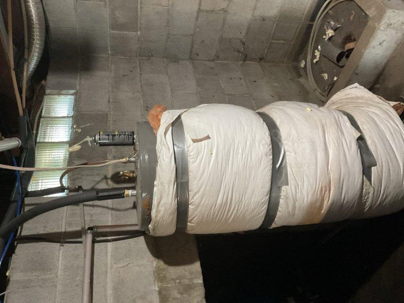 Responded to a no-cooling call on a 2002 ICP R-22 air conditioning system paired with a 2013 York high-efficiency furnace. Upon arrival, confirmed the outdoor unit would not start—neither the compressor nor condenser fan motor was running. Performed diagnostic testing on the outdoor dual run capacitor and found it had failed completely, testing at 0/0 µF versus its rated capacity of 30/5 µF. Visual inspection revealed the capacitor was visibly bulged and swollen, confirming internal failure. Replaced the failed dual run capacitor with a new unit matching the original specifications. Restarted the system and verified proper operation of both the compressor and condenser fan motor. Measured supply and return air temperatures and confirmed a 22°F temperature split, indicating the system was cooling normally and performing within acceptable parameters for an R-22 refrigerant system. During inspection of the mechanical room, discovered a 10-year-old Richmond electric water heater with activ