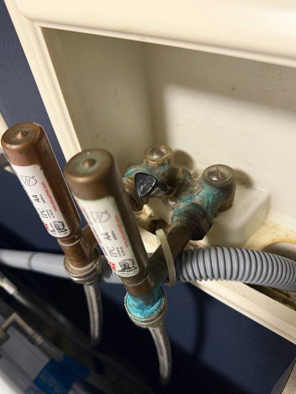 Responded to service call for leaking outdoor hose bib and leaking washing machine supply valves. Upon inspection, found both fixtures experiencing persistent leaks due to debris accumulation in water lines following recent calcite treatment to the property's water system, causing valve seats and internal components to stick and fail to seal properly. The debris from the water treatment system had compromised the integrity of the existing brass fixtures, resulting in both the exterior hose bib and dual washing machine valves requiring replacement. Removed and replaced the corroded outdoor hose bib with new frost-proof sillcock. Replaced the dual brass washing machine valve assembly with new Everbilt 1/2-inch MIP/SWT x 3/4-inch MHT brass dual washing machine valve, ensuring proper thread seal and connection integrity. Tested both new fixtures under full water pressure to verify complete elimination of leaks and proper shut-off functionality.