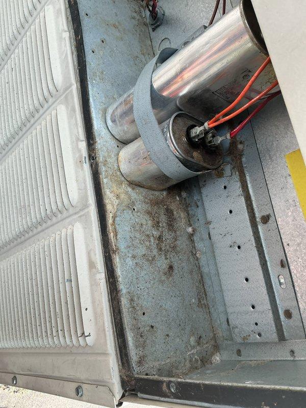 Responded to callback for 15-year-old air conditioning system with no cooling and reported system failure. Upon arrival, unit was operational after customer had reset tripped breaker. Performed comprehensive electrical diagnostics and amp draw testing on compressor circuit. Testing revealed compressor drawing excessive amperage beyond rated specifications, causing circuit breaker to trip under load. Inspected electrical connections, contactors, and capacitor at outdoor unit. Documented equipment condition with photos showing weathered electrical panel, wire connections, and compressor components with visible age-related deterioration including rust and discoloration on metal surfaces. Advised customer that failing compressor poses safety concern and will continue to trip breaker, resulting in system failure. Scheduled appointment with comfort advisor to review replacement options for aging system.