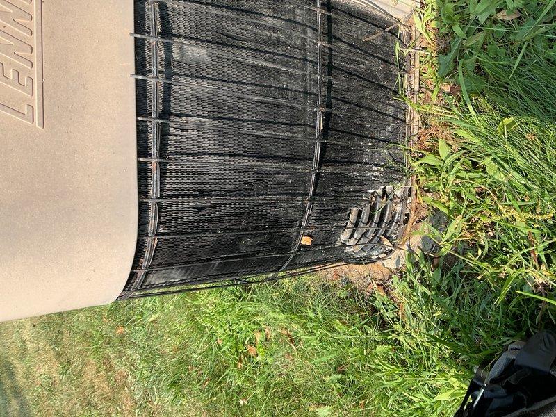 Responded to customer complaint of air conditioning unit running continuously with minimal cooling capacity. Upon inspection, found a 1990 Lennox condenser with R-22 refrigerant paired with a 2013 Lennox furnace. Performed diagnostic testing after 15 minutes of runtime using Job Link analyzer, which revealed critically low refrigerant charge with system temperature differential of only 5°F and standing pressure of 124 psig on a 90°F ambient day. Visual inspection showed outdoor condenser unit with significantly soiled coil fins, heavy debris accumulation including leaves and organic matter trapped between fins, and overgrown vegetation surrounding the base of the unit. Removed and inspected air filter, which showed signs of dirt buildup. All diagnostic findings confirmed substantial refrigerant loss and severely compromised cooling capacity. Given the age of the equipment, obsolete R-22 refrigerant type, extent of refrigerant loss, and overall system condition, recommended system repla