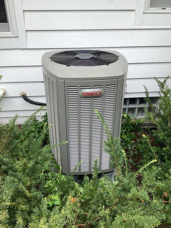 Responded to callback for system freezing issues and fault codes. Cleared outdoor coil of cottonwood debris and verified system operating at 13-degree subcooling (target 14 degrees). Adjusted airflow from 975 CFM to proper 800 CFM for 2-ton system, achieving 20-degree delta T. Diagnosed communication faults present since installation; corrected bleeder wire landing on shielded wiring to C terminal. Identified spliced thermostat wire as primary issue causing intermittent blower motor codes and communication errors. Consulted with technical support who confirmed ongoing communication faults via remote fault history review. Recommended running two separate, non-spliced thermostat wires to resolve persistent communication issues before proceeding with further diagnostics.
