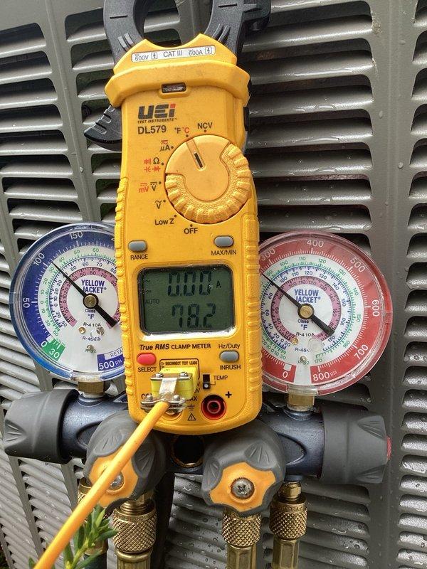 Responded to callback for system freezing issues and fault codes. Cleared outdoor coil of cottonwood debris and verified system operating at 13-degree subcooling (target 14 degrees). Adjusted airflow from 975 CFM to proper 800 CFM for 2-ton system, achieving 20-degree delta T. Diagnosed communication faults present since installation; corrected bleeder wire landing on shielded wiring to C terminal. Identified spliced thermostat wire as primary issue causing intermittent blower motor codes and communication errors. Consulted with technical support who confirmed ongoing communication faults via remote fault history review. Recommended running two separate, non-spliced thermostat wires to resolve persistent communication issues before proceeding with further diagnostics.