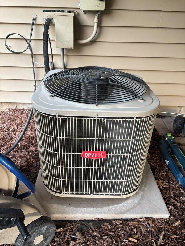 Responded to no cooling complaint on 11-year-old Bryant air conditioning system. Customer reported unit was operational until previous day when condenser attempted to start but failed to run. Upon inspection, diagnosed failed capacitor preventing compressor and condenser fan motor from starting. Replaced defective capacitor with proper OEM replacement. Installed locking caps on refrigerant service ports to prevent tampering and refrigerant loss. Cycled system through complete cooling operation to verify proper startup, amperage draw, and temperature split. Unit restored to normal cooling operation.