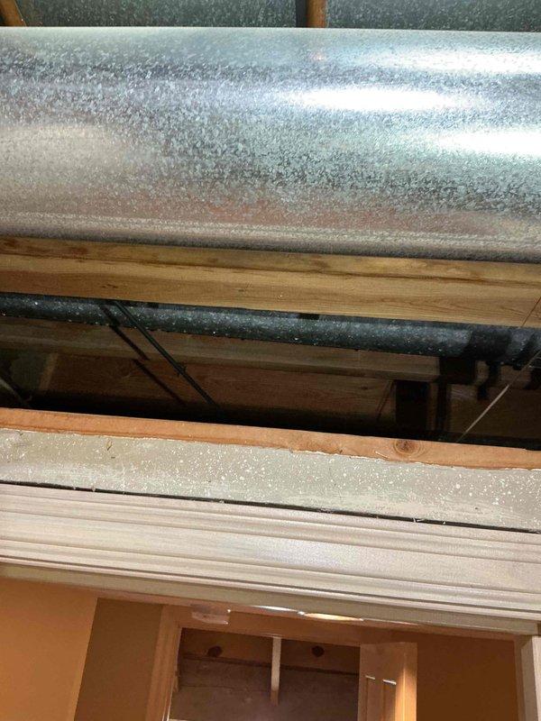 Responded to callback for HVAC unit less than 10 years old with worsening condensation issues on supply air ducts. Upon inspection, confirmed extensive condensation and frost buildup on supply ductwork in attic space, indicating excessive humidity levels and inadequate insulation. Verified system operation and documented conditions with photographs showing moisture accumulation on metal ductwork and active system components with green LED indicator confirming power. Provided recommendations to customer including installation of whole-home dehumidifier to control indoor humidity levels and temporary use of lower MERV-rated air filter to improve airflow and reduce system strain until permanent solution implemented.