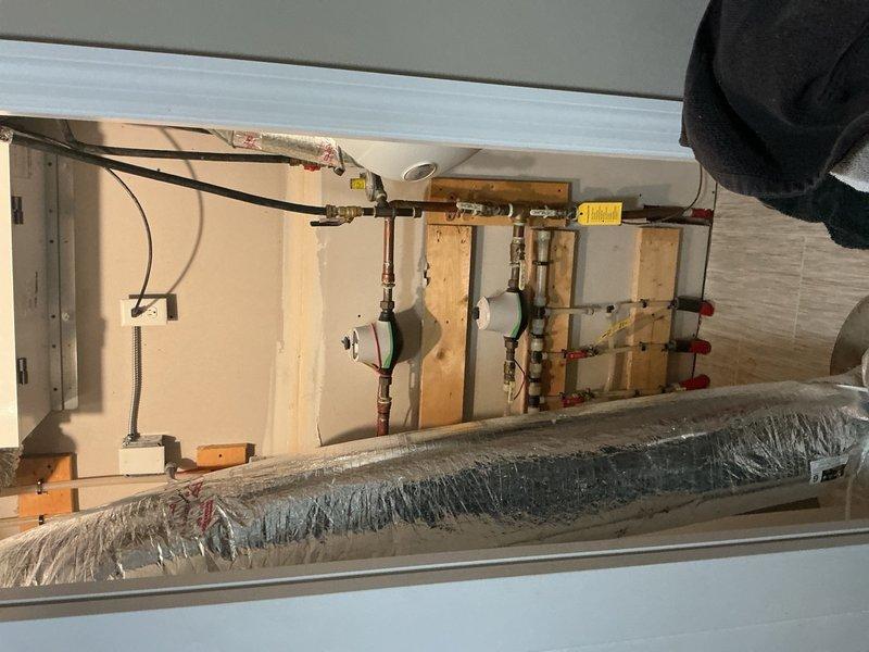 Responded to water leak at guest bathroom sink base and provided estimates for necessary plumbing repairs and upgrades. Assessed lavatory faucet requiring replacement, outdoor hose bibb needing installation, and water softener system requirements. Documented existing plumbing infrastructure including copper supply lines with shut-off valves and utility room configuration for future work authorization.