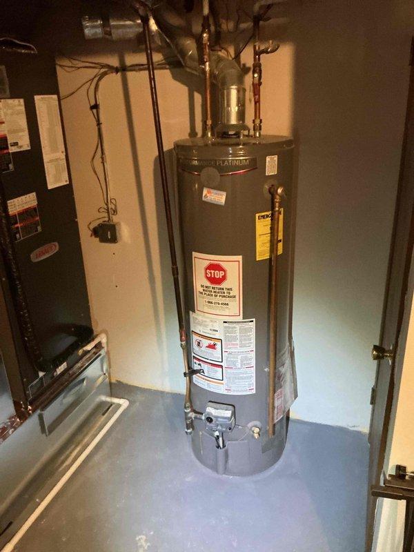 Relocated Rheem Platinum water heater approximately 4 inches to the right to provide adequate clearance for furnace filter access and replacement. Repositioned unit with all copper supply lines, fittings, and connections maintained in proper working order.