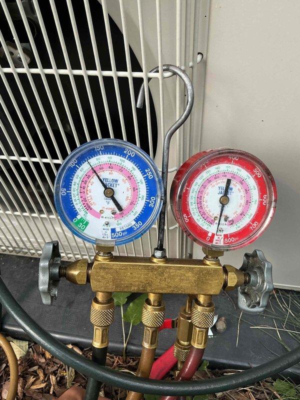 Responded to no cooling complaint on 2019 Mitsubishi mini split system with previous motherboard replacement history from 2022. Performed diagnostic testing and pressure checks using manifold gauge set, which revealed low refrigerant charge as the cause of insufficient cooling. Added refrigerant to restore system to proper operating levels and verified cooling performance upon completion.