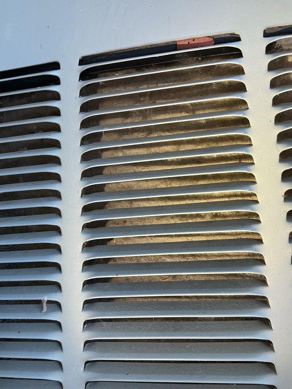 Responded to no cooling complaint on R-22 system with fans running but no cooling output. Upon arrival, verified thermostat calling for cooling and confirmed air filter in acceptable condition. Inspection of outdoor unit revealed condenser coils heavily obstructed with cottonwood debris, resulting in zero airflow through coil. Refrigerant pressure readings showed equalized suction and discharge pressures, indicating compressor not running. Tested run capacitor which measured 0 MFD out of rated 20 MFD, confirming complete capacitor failure as root cause of no cooling condition. Replaced failed run capacitor with new unit to manufacturer specifications. System startup successful with compressor now operating. Initial pressure readings and delta-T of 10 degrees appeared slightly abnormal due to severely restricted airflow from clogged condenser coil. Advised property owner of critical need for condenser coil cleaning to restore proper airflow and system efficiency. Customer elected to per