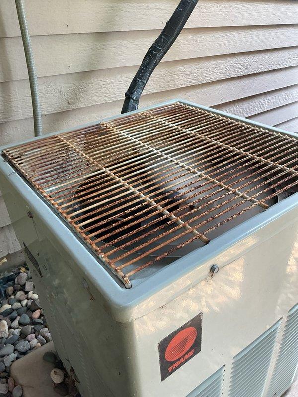 Responded to no cooling complaint on R-22 system with fans running but no cooling output. Upon arrival, verified thermostat calling for cooling and confirmed air filter in acceptable condition. Inspection of outdoor unit revealed condenser coils heavily obstructed with cottonwood debris, resulting in zero airflow through coil. Refrigerant pressure readings showed equalized suction and discharge pressures, indicating compressor not running. Tested run capacitor which measured 0 MFD out of rated 20 MFD, confirming complete capacitor failure as root cause of no cooling condition. Replaced failed run capacitor with new unit to manufacturer specifications. System startup successful with compressor now operating. Initial pressure readings and delta-T of 10 degrees appeared slightly abnormal due to severely restricted airflow from clogged condenser coil. Advised property owner of critical need for condenser coil cleaning to restore proper airflow and system efficiency. Customer elected to per