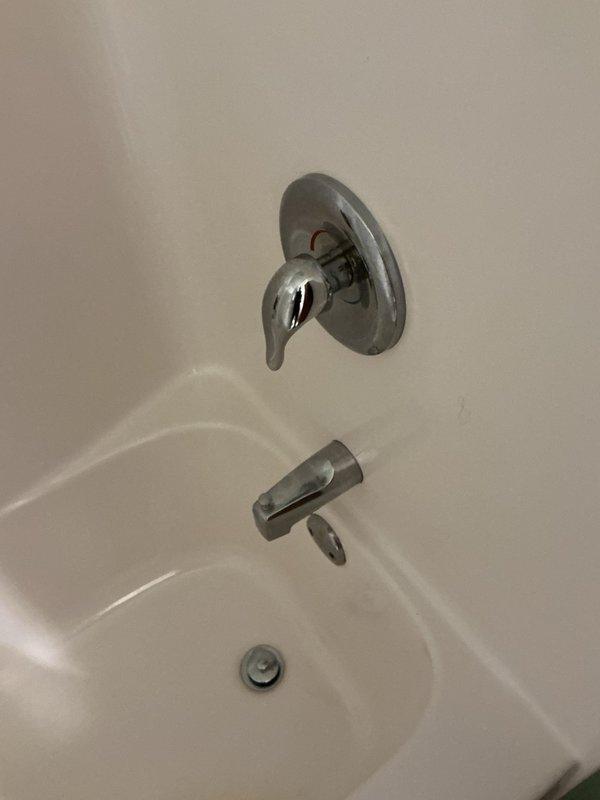 Completed annual plumbing inspection in response to reported low water pressure issues. Conducted thorough examination of bathroom fixtures including tub/shower valve assembly and spout with diverter mechanism, as well as basement water treatment system consisting of dual water softener/filtration units with digital controls and associated PVC supply and distribution plumbing. All fixtures and equipment photographed and documented for service records.