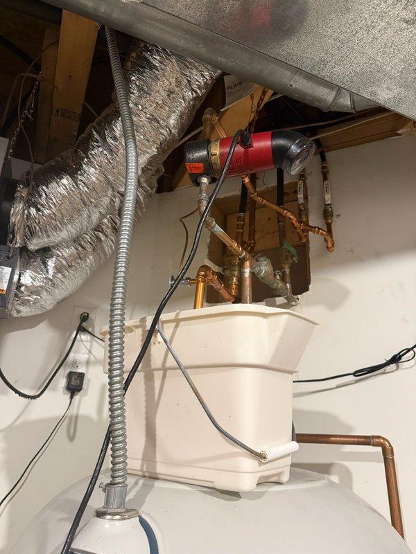 Responded to reported leak at top of 2011 Marathon water heater unit. Upon inspection, determined the leak was originating from the hot water circulating pump mounted above the water heater, not from the tank itself. Documented existing conditions with photographs showing the pump installation, copper piping connections, and overall water heater setup. Circulating pump requires replacement to resolve the active leak. Customer will be scheduled for follow-up appointment to complete pump replacement and restore proper operation of the recirculation system.