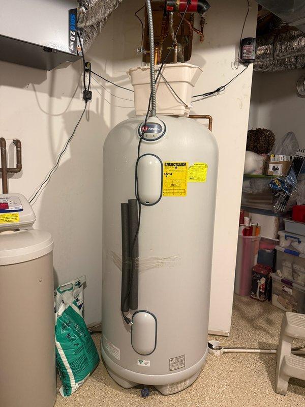 Responded to reported leak at top of 2011 Marathon water heater unit. Upon inspection, determined the leak was originating from the hot water circulating pump mounted above the water heater, not from the tank itself. Documented existing conditions with photographs showing the pump installation, copper piping connections, and overall water heater setup. Circulating pump requires replacement to resolve the active leak. Customer will be scheduled for follow-up appointment to complete pump replacement and restore proper operation of the recirculation system.