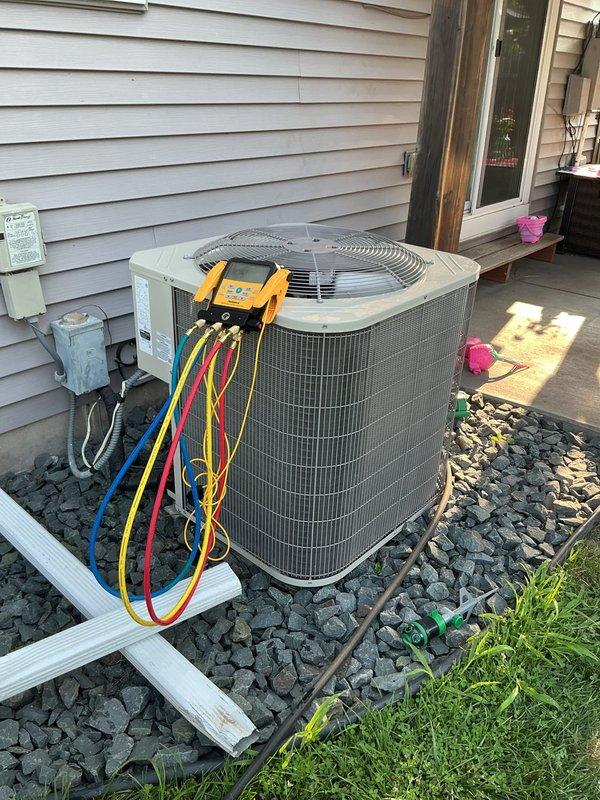 Responded to no cooling complaint on one-year-old air conditioning system experiencing intermittent condenser operation and warm air delivery. Diagnostic testing with manifold gauges revealed low refrigerant charge causing system to cycle off prematurely. Customer will contact original installer to address refrigerant leak and recharge system under warranty.