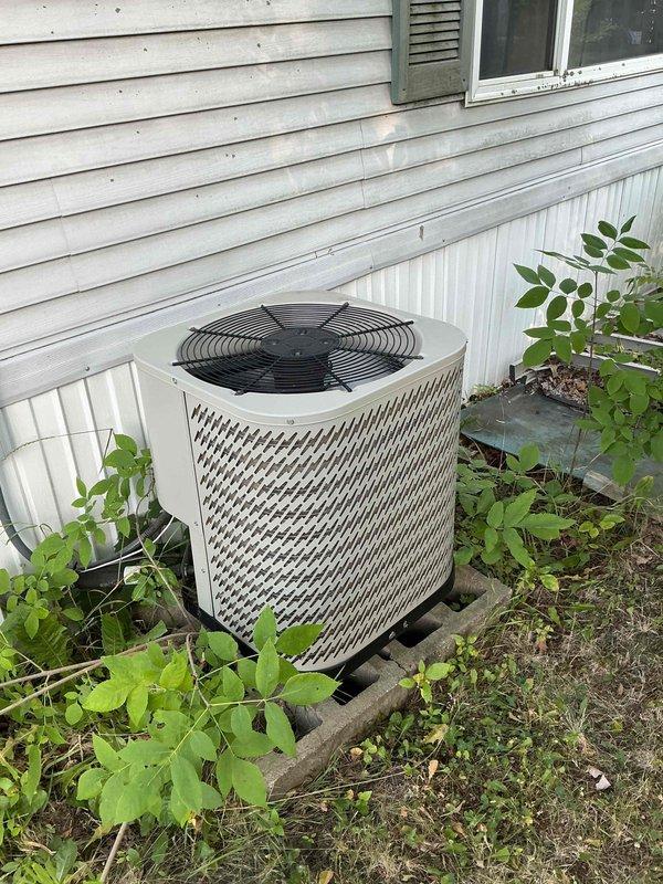 Responded to service call for air conditioning system not maintaining adequate cooling. Upon inspection, found unit operational but inefficient. Identified heavily soiled and plugged condenser coil restricting airflow. Performed thorough cleaning and rinse of condenser coil. Verified all electrical components were functioning within manufacturer specifications. After cleaning, system continued to underperform. Connected manifold gauges and diagnosed low refrigerant charge. Added approximately one pound of refrigerant and UV dye to system per customer authorization. System now operating properly with improved cooling capacity.