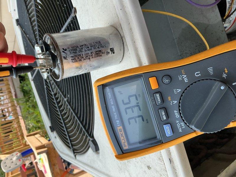 Completed annual maintenance on 2004 Lennox AC system utilizing R410-A refrigerant. Performed comprehensive inspection of outdoor condensing unit including electrical components, capacitor testing, contactor evaluation, and refrigerant charge verification. Capacitor tested at 33/3 microfarads against rated 35/4 specification, reading within acceptable range despite visible fluid leakage on exterior casing; advised of condition for future replacement consideration. Verified all electrical wiring connections secure with no signs of deterioration or overheating. Contactor operation normal with proper contact engagement. Refrigerant charge confirmed at proper levels with no indication of leaks. Indoor unit inspection revealed dirty air filter requiring replacement, contributing to delta-T reading of 15 degrees. Blower motor operation confirmed at appropriate speed with adequate airflow once filter condition noted. System operational and cooling effectively at time of service completion.