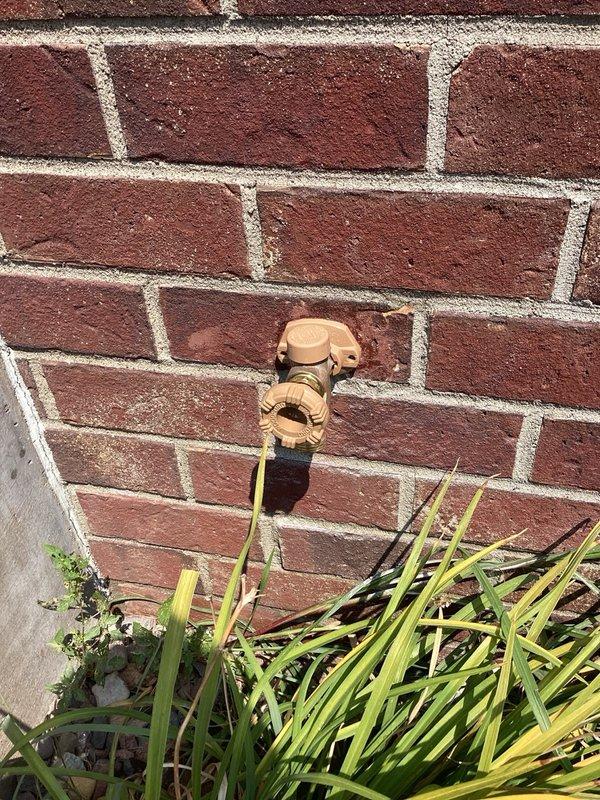 Responded to service call for leaking outdoor hose bibb mounted on exterior brick wall. Upon inspection, confirmed active water leak from the existing fixture. Removed the deteriorated hose bibb and installed new replacement unit with proper sealing to prevent future leaks. Tested new installation to verify proper water flow and confirmed no leakage at connection points.