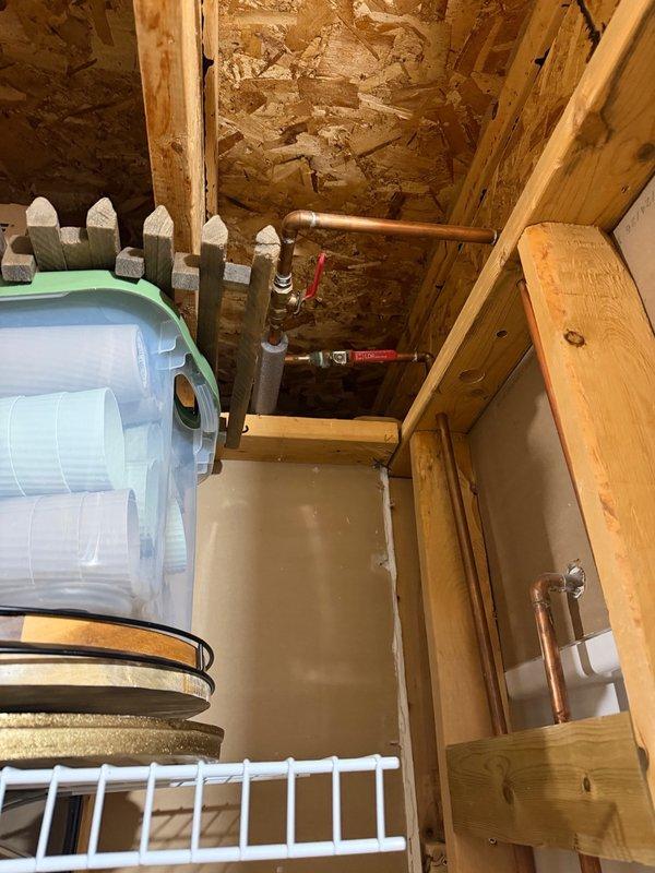 Replaced and installed Kohler shower valve in basement utility area. Completed rough-in plumbing installation with copper pipe connections and PEX transitions, ensuring proper valve operation and secure mounting within exposed wall framing.