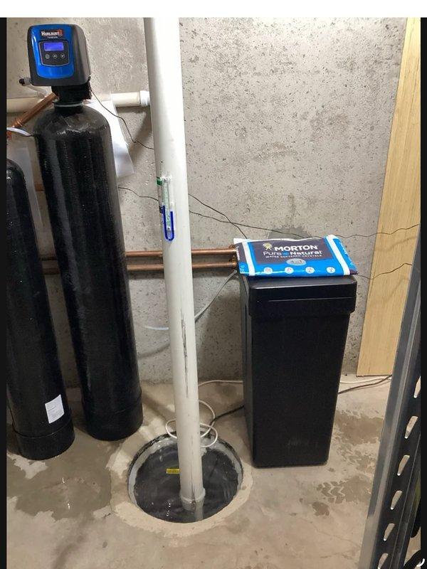 Responded to no-power issue affecting water softener system installed last November. Found tripped GFI outlet causing complete power loss to water treatment units and radon mitigation fan. Reset GFI receptacle, restoring power to all equipment. Verified operational status of dual-tank water treatment system with digital control heads. Adjusted system parameters by reducing backwash cycle duration on carbon filtration tower and extending regeneration intervals to optimize performance and efficiency.
