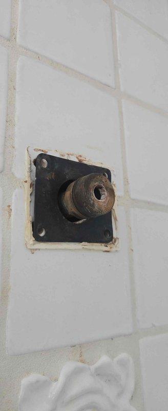Responded to service call for broken shower fixture requiring faucet replacement. Upon inspection, identified severely corroded shower valve stem and deteriorated mounting assembly with extensive rust damage affecting surrounding tile area. Documented existing conditions showing failed valve cartridge with compromised seals and oxidized metal components. Submitted parts order form for replacement shower valve assembly and necessary hardware to complete installation at owner-occupied residence.