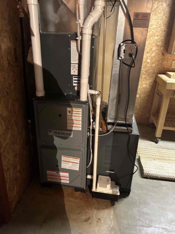 Responded to no cooling concern on 9-year-old Daikin system. Upon arrival, thermostat was set to 73°F and maintaining setpoint. Performed comprehensive system evaluation and maintenance tune-up. Cleaned outdoor condenser coil with water to remove debris and restore airflow. Inspected all electrical connections and components at condensing unit – found secure and within specifications. Evaluated indoor evaporator coil operation – confirmed proper refrigerant flow with full coil sweating pattern. Measured temperature split across evaporator at 18°F, indicating correct system performance. Verified all indoor components functioning properly. Explained to homeowner that recent perceived cooling inadequacy was due to extreme weather conditions with mid-90s temperatures and high humidity levels, which exceed normal design parameters for residential equipment. System operating as designed with no deficiencies found.