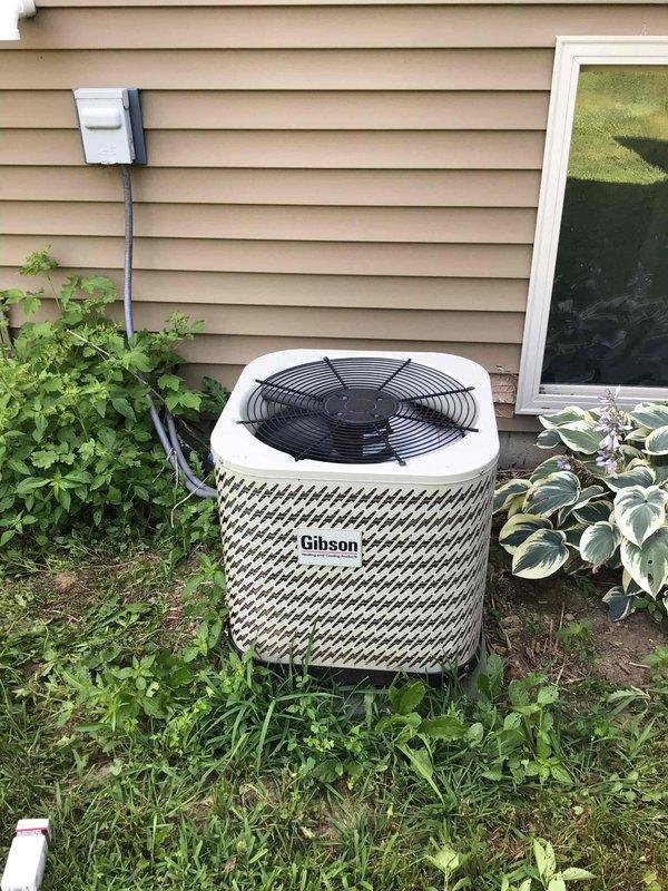 Responded to a no-cool call on a 12-year-old Gibson central air conditioning system where the outdoor condensing unit was not operating. Upon inspection, tested the run capacitor and found it completely failed with no charge. Replaced the defective capacitor with a new unit, restoring immediate operation to the compressor and condenser fan, with the system achieving a 20-degree temperature split across the evaporator coil, confirming proper cooling capacity.