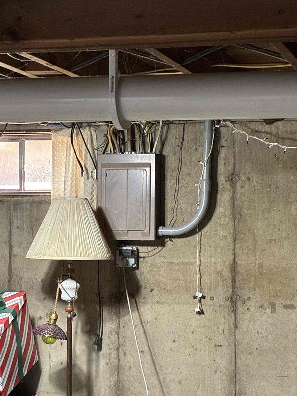 Performed preventive maintenance on 17-year-old residential air conditioning system including condenser coil cleaning, electrical component inspection, and drain line service. During inspection, identified failing dual-run capacitor reading 27/4 MFD on a rated 35/5 MFD unit. Contactor tested within specifications, and fan motor operation verified normal. Indoor air filter found clean, condensate drain cleared, and temperature differential measured at 17 degrees. Replaced defective capacitor with new unit per manufacturer specifications and confirmed proper system operation with normal cooling performance restored.