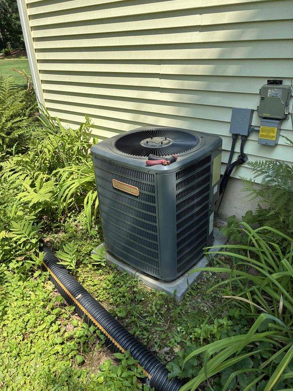 Performed preventive maintenance on 17-year-old residential air conditioning system including condenser coil cleaning, electrical component inspection, and drain line service. During inspection, identified failing dual-run capacitor reading 27/4 MFD on a rated 35/5 MFD unit. Contactor tested within specifications, and fan motor operation verified normal. Indoor air filter found clean, condensate drain cleared, and temperature differential measured at 17 degrees. Replaced defective capacitor with new unit per manufacturer specifications and confirmed proper system operation with normal cooling performance restored.