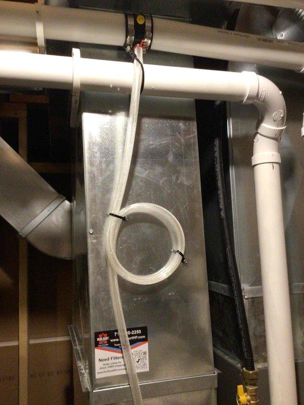 Returned to address condensation leak issue on high-efficiency HVAC system installed less than one year ago. Installed condensate drain kit to resolve water leakage problem. Verified proper drainage by leaving pipe end open during testing to confirm no water bypassed the kit. All condensate lines now draining properly with no leaks detected.