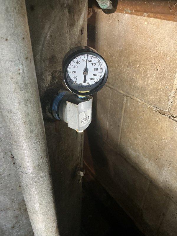 Responded to customer complaint of leaking air volume control valve on water heater system. Upon inspection, confirmed the existing air volume control valve was failing and actively leaking. Removed the defective valve and installed a new air volume control valve to restore proper system function. Verified system pressure reading at approximately 60 PSI on gauge after installation. System tested and operating correctly with no leaks detected.