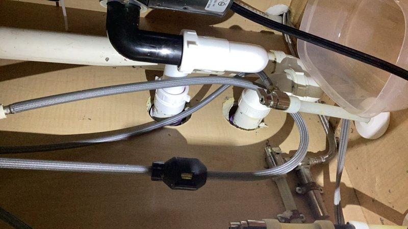 Responded to clogged kitchen sink on disposal side of double-basin sink where water was not draining and garbage disposal was inoperative. Disassembled and cleared the P-trap assembly beneath the garbage disposal, removing accumulated debris causing the blockage. Reassembled drain components, tested system for proper drainage and verified garbage disposal operation restored to normal function.
