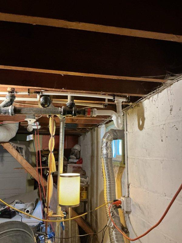 Responded to service call for slow bathroom drains with standing water in tub. Upon inspection, found kitchen sink and lavatory sink drains were restricted but functional, while the tub drain was severely clogged. Identified outdated drum trap on tub drain that was no longer compliant with current plumbing code.

Removed the non-compliant drum trap and replaced it with a new P-trap, making all necessary connections to the existing drain lines. Cabled the drain line and successfully extracted a large hair obstruction causing the blockage. After completion of repairs, performed operational testing by filling and dumping the tub multiple times to verify proper drainage and inspect for leaks. All systems tested successfully with no leaks detected and full drainage restored to code-compliant standards.