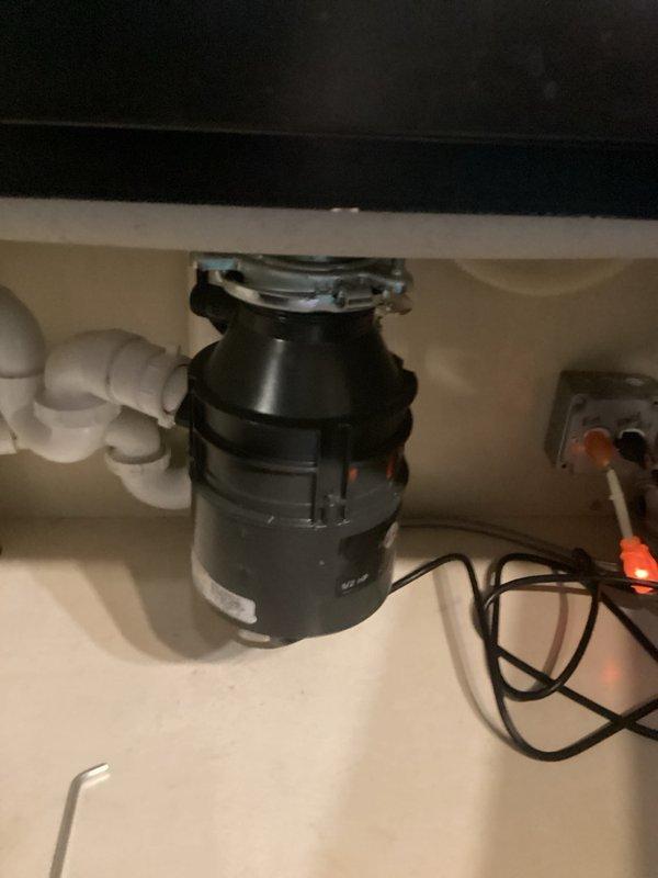 Installed customer-provided InSinkErator 1.0HP garbage disposal unit under kitchen sink, including mounting assembly, drain connections, and P-trap plumbing. Supplied and connected power cord to disposal unit and verified proper electrical connection at wall outlet. Tested unit for proper operation and confirmed all connections were secure with no leaks.