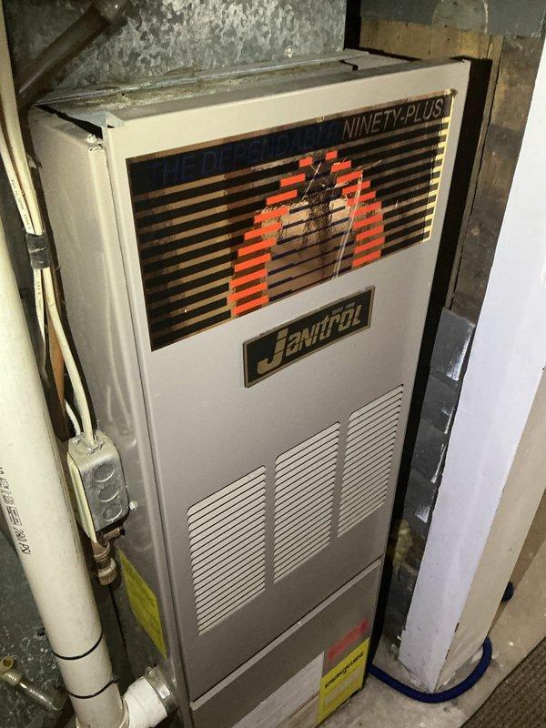 Responded to no cooling complaint on 33-year-old R22 system experiencing coil freeze-up. Upon arrival, diagnosed low refrigerant charge as primary cause of icing condition. During inspection, identified signs of low-level carbon monoxide leakage from furnace burner compartment front cover. Advised system shutdown and fan-only operation to allow complete defrost of evaporator coil prior to service. Documented equipment condition with photographs showing Janitrol Ninety-Plus furnace installation and overall system age. Due to obsolete R22 refrigerant, advanced system age exceeding service life expectancy, and safety concerns with carbon monoxide detection, recommended comfort advisor consultation for system replacement options.