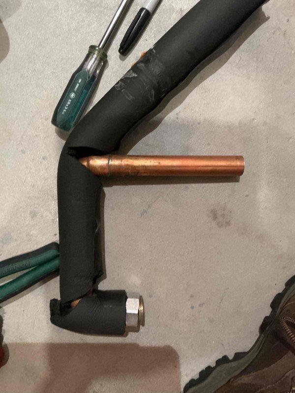 Removed existing mixing valve from water heating system and installed new brass mixing valve with coupling to properly regulate water temperature. System tested and verified operational with appropriate temperature control functionality restored.