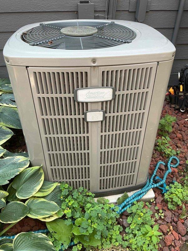 Responded to no cooling call on 17-year-old American Standard air conditioning system. Upon arrival, found unit buzzing but condenser fan motor not operating. Diagnosed failed dual run capacitor as root cause of system failure. Replaced defective capacitor and verified proper system operation. Performed complete system inspection including contactor functionality, condenser coil cleanliness, refrigerant charge levels, and air filter condition—all found to be within acceptable parameters. System restored to full cooling operation. Discussed equipment age and available options with homeowner given the advanced age of the unit.