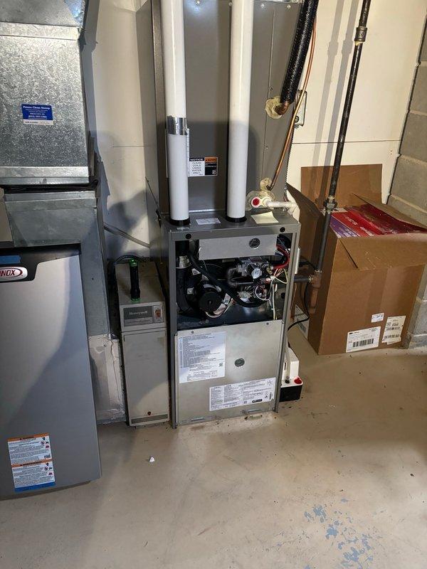 Responded to no-cool complaint on Lennox air conditioning system. Upon arrival with 85°F outdoor ambient, found unit was cooling but unable to maintain 74°F setpoint due to multiple contributing factors. Measured subcooling at 11° versus manufacturer target of 5°, indicating overcharged refrigerant circuit. Recovered 8 oz of refrigerant to bring charge to proper specification. Verified airside performance with return air temperature at 70.5°F and supply air at 53°F, yielding acceptable 17.5°F temperature split.

Identified restricted airflow caused by decorative wood supply register covers significantly limiting air delivery throughout home. Removed restrictive covers to improve supply air velocity and system performance. Conducted thermal inspection revealing major heat gain issue at hallway attic fan located above thermostat, with surface temperatures measuring 108°F at louvers due to missing insulation and inadequate sealing. This radiant heat was influencing thermostat sensing and 