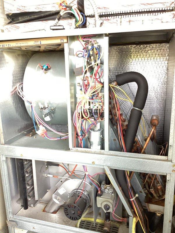 Responded to no cooling complaint on residential HVAC system over 10 years old with visible mold present in equipment closet. Upon inspection, found critically low refrigerant pressure on low side indicating significant refrigerant leak in system. Additionally discovered compressor producing abnormal grinding and metallic noise suggesting internal mechanical failure. Removed access panels and documented internal condition of air handler and condensing unit components including wiring, refrigerant lines, evaporator coil, and compressor assembly. Advised customer of dual failure conditions requiring both leak repair and likely compressor replacement, provided repair options and recommendations for system given age and extent of failures.