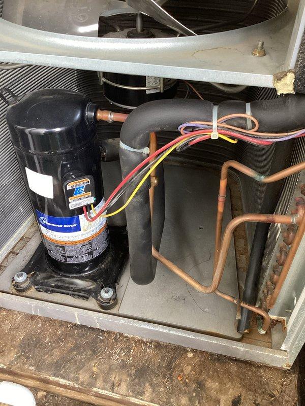 Responded to no cooling complaint on residential HVAC system over 10 years old with visible mold present in equipment closet. Upon inspection, found critically low refrigerant pressure on low side indicating significant refrigerant leak in system. Additionally discovered compressor producing abnormal grinding and metallic noise suggesting internal mechanical failure. Removed access panels and documented internal condition of air handler and condensing unit components including wiring, refrigerant lines, evaporator coil, and compressor assembly. Advised customer of dual failure conditions requiring both leak repair and likely compressor replacement, provided repair options and recommendations for system given age and extent of failures.