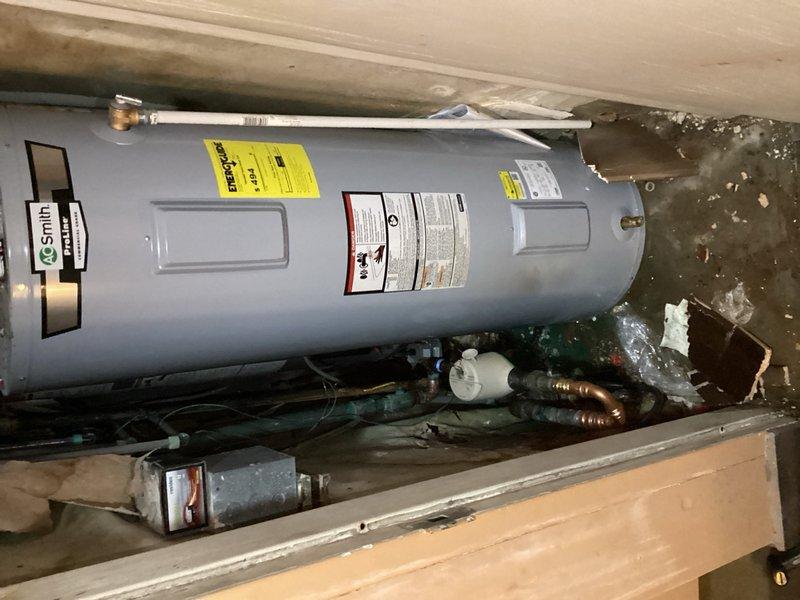 Responded to emergency water leak in building's main water line. Upon arrival, identified pinhole leak in corroded copper pipe adjacent to the main water supply line near the meter. The shutoff valve and surrounding pipe showed significant corrosion from age and moisture exposure. Isolated the affected section by shutting off water supply to the entire building from the street-level main valve to prevent further water damage and allow safe repairs.

Cut out the compromised section of copper pipe containing the pinhole leak and replaced with new piping and fittings. Completed proper soldering and connections to restore water main integrity. Tested all connections for leaks and verified proper water pressure throughout the system. Restored water service to the building and confirmed shutoff valve operation. Documented existing conditions including water pooling on concrete floor and moisture damage in the utility area, along with corroded plumbing components requiring monitoring for futu